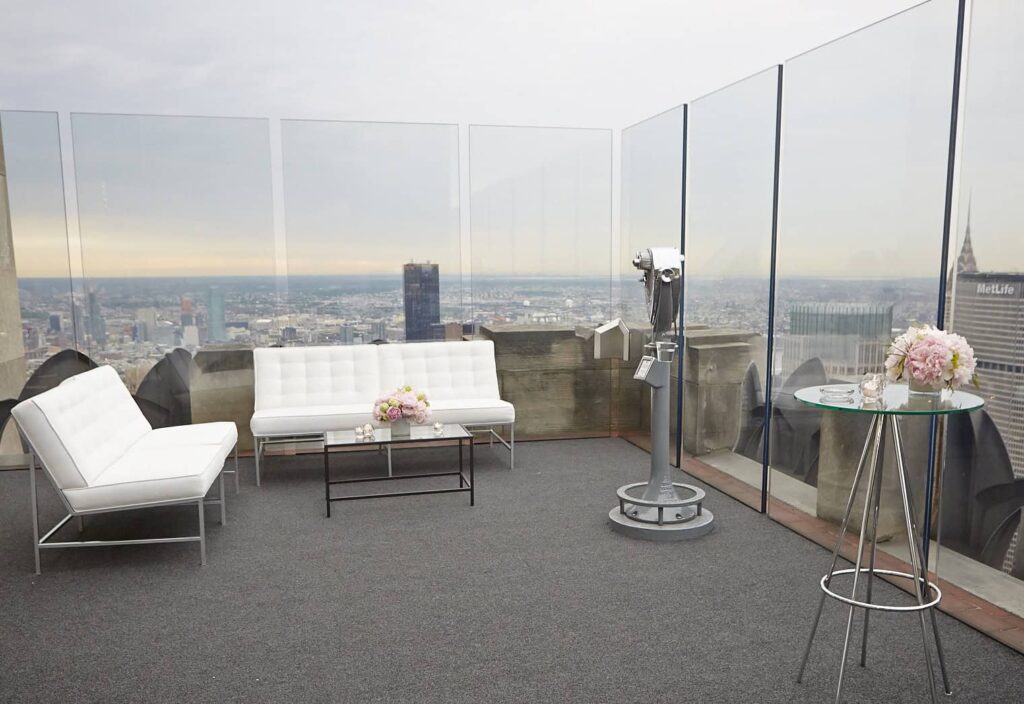 a bunch of couches on the top of a skyscraper