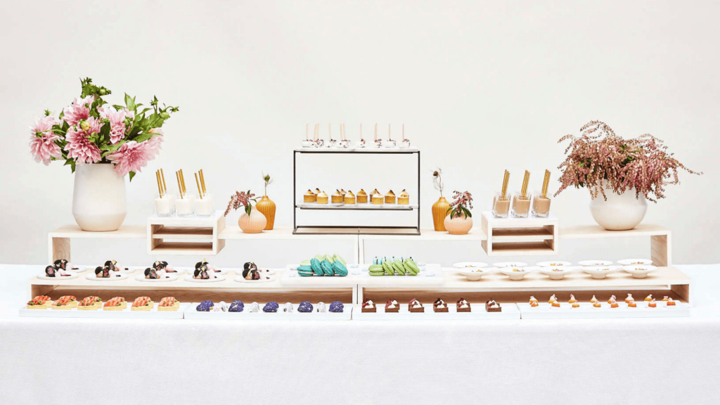 a bunch of good food on a table in front of a giant white wall