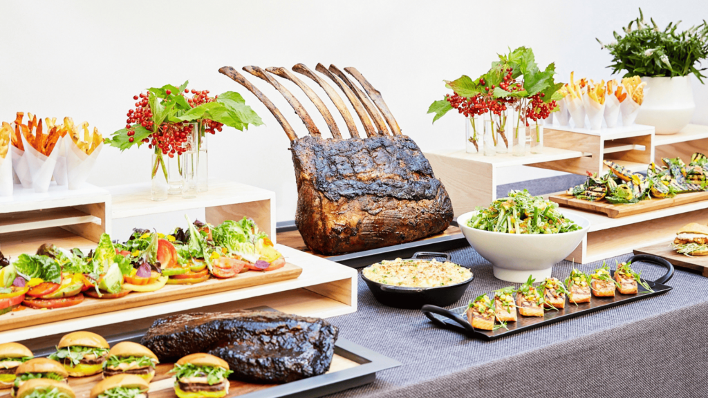 a bunch of food and meats on a table ready for people to eat