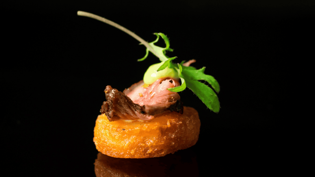 a dish of food with a black backround behind it