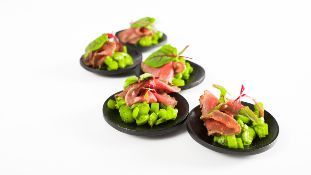 A bunch of little dishes with vegetables in each of them