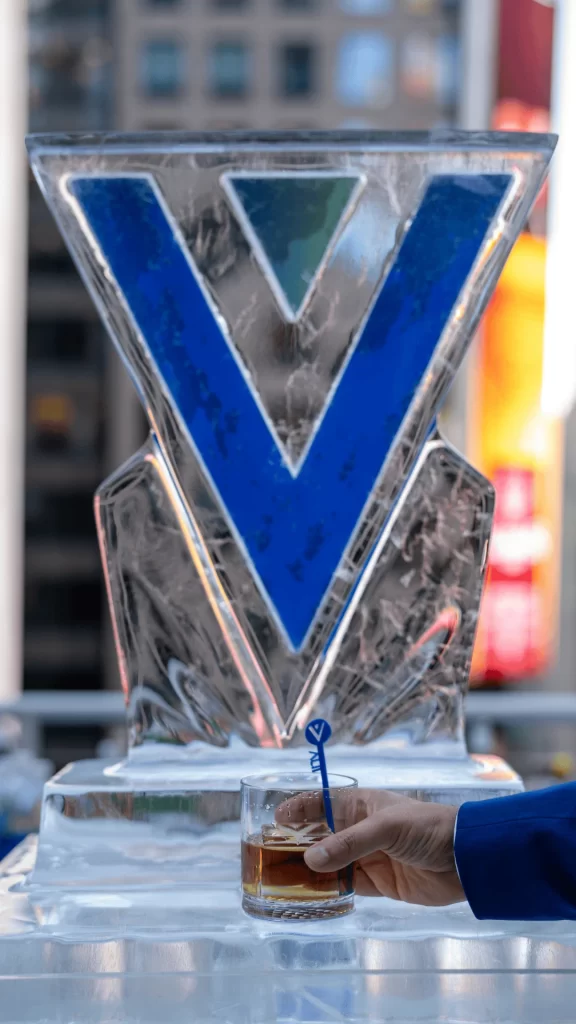 A branded piece of ice with a person drinking