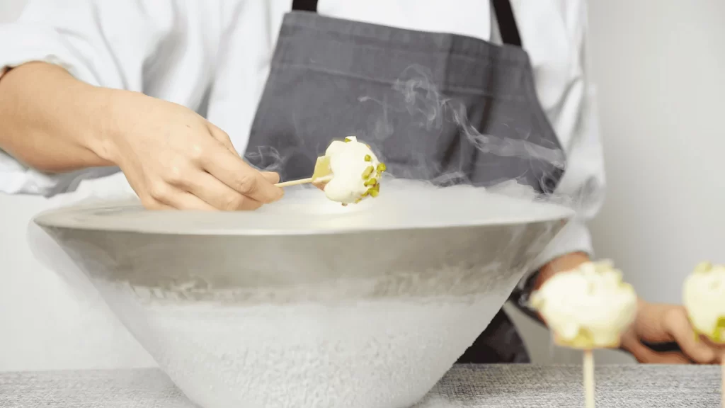 A man freezing desserts for a dessert catering event