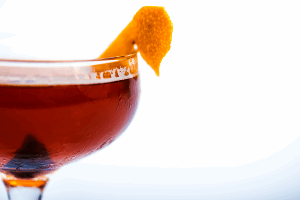 An alcoholic drink with a piece of food sitting inside it