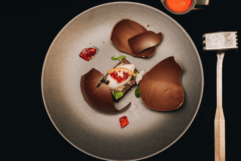 A plate of dessert that was broken open by a metal hammer